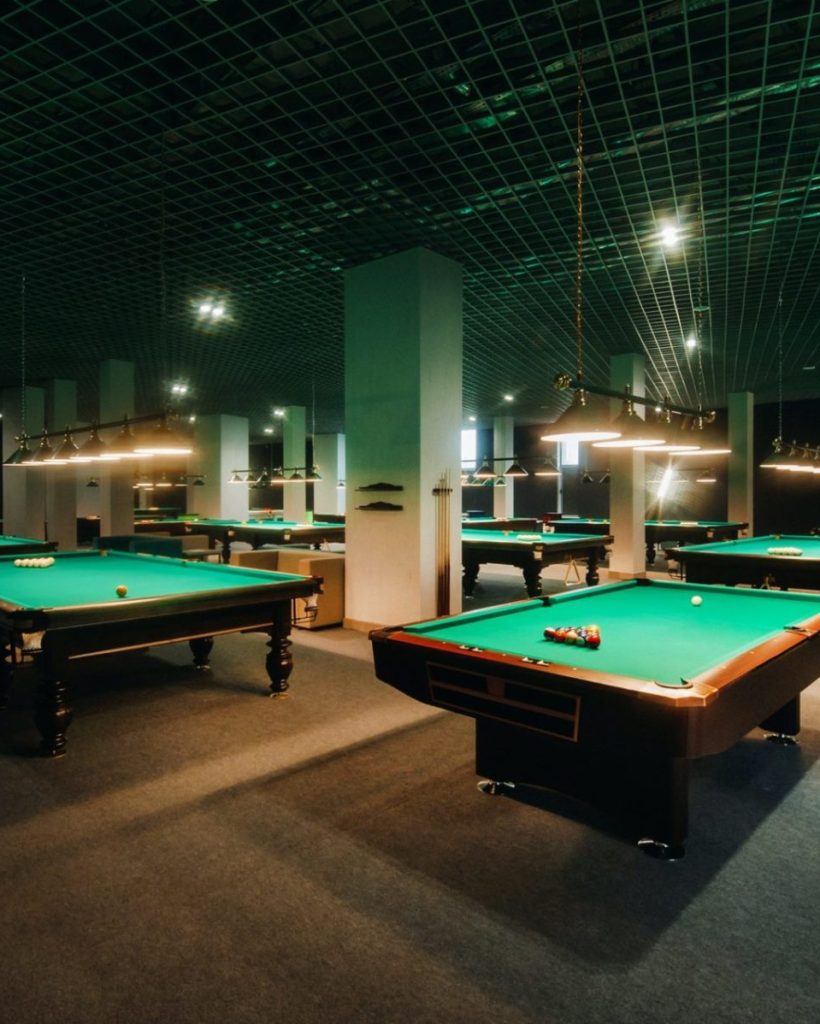 billiard-table-with-green-surface-and-balls-in-the-billiard-club-pool-game-e1640711989794.jpg