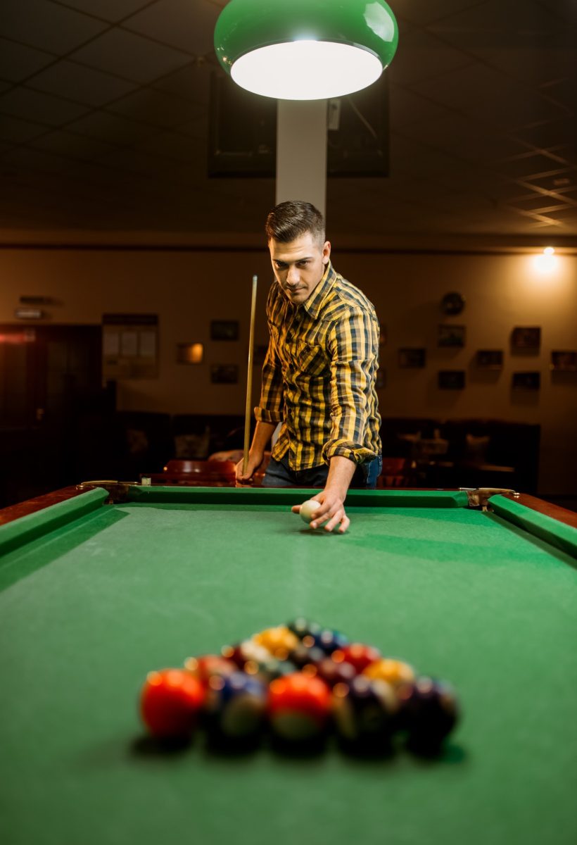 male-billiard-player-with-cue-aiming-at-the-table.jpg